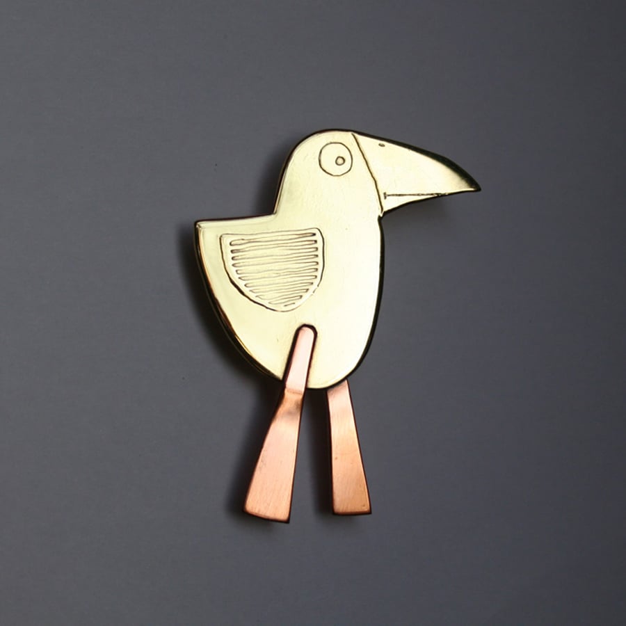 bird brooch with long pink legs