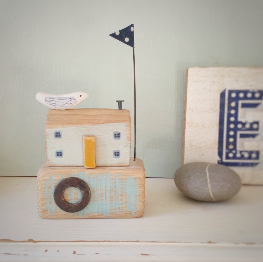 SALE - Wood seahouse with clay bird and spotty flag