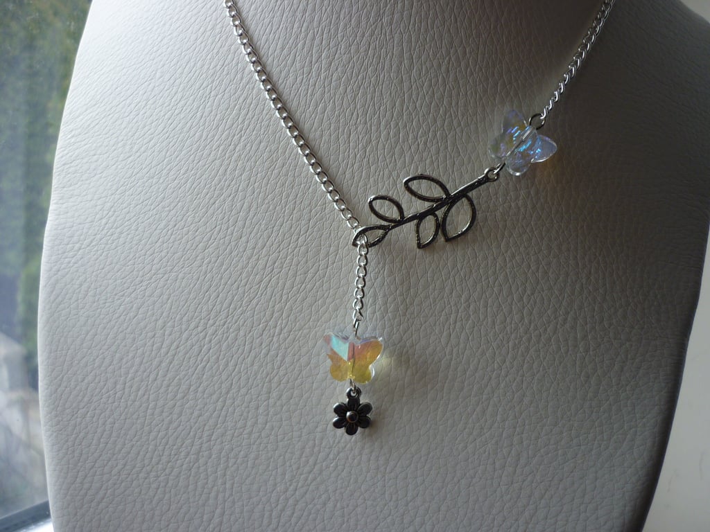 AB CRYSTAL AND SILVER, BUTTERFLY, LEAF AND FLOWER LARIAT NECKLACE.