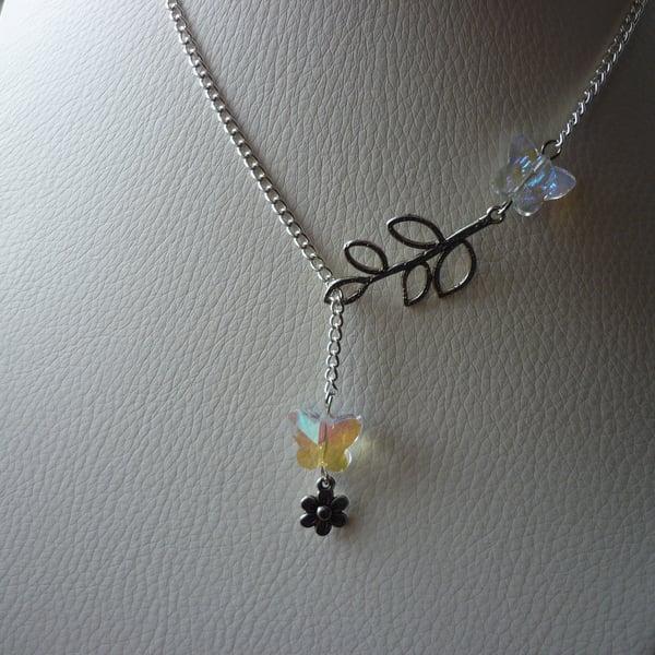 AB CRYSTAL AND SILVER, BUTTERFLY, LEAF AND FLOWER LARIAT NECKLACE.