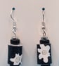 Black paper beaded earrings with white flower patterns - Image 3