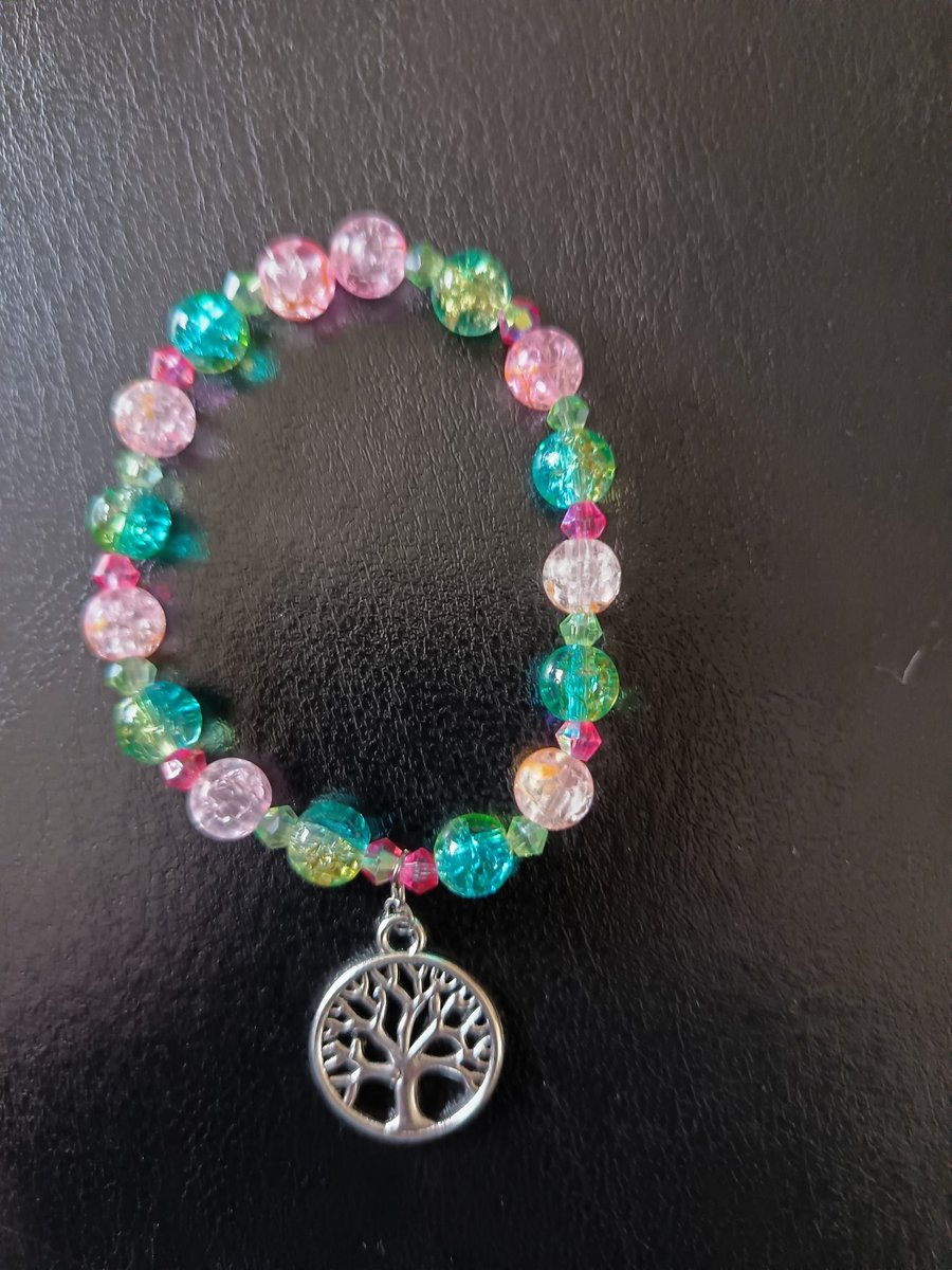 Elasticated tree of life charm bracelet with green and pink glass beads