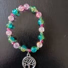 Elasticated tree of life charm bracelet with green and pink glass beads
