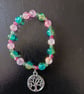 Elasticated tree of life charm bracelet with green and pink glass beads