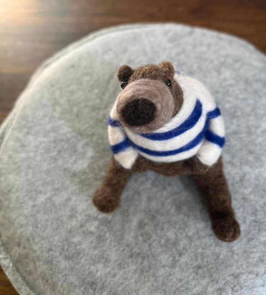 Needle felted brown bear in striped top.