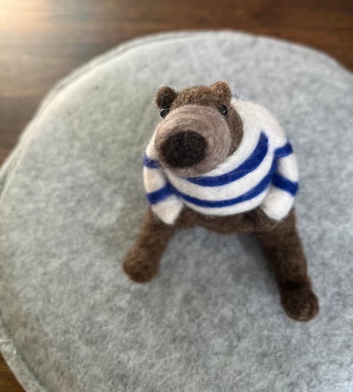 Needle felted brown bear in striped top.
