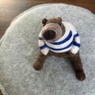 Needle felted brown bear in striped top.