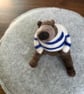 Needle felted brown bear in striped top.