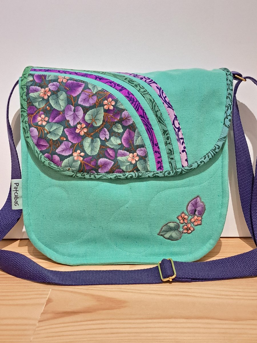 Mint green handbag with green and violet leaves 