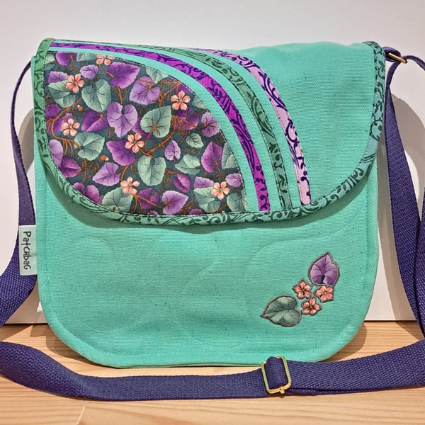 Mint green handbag with green and violet leaves 