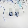 Rectangle white and blue enamel and copper studs with hand drawn detail.