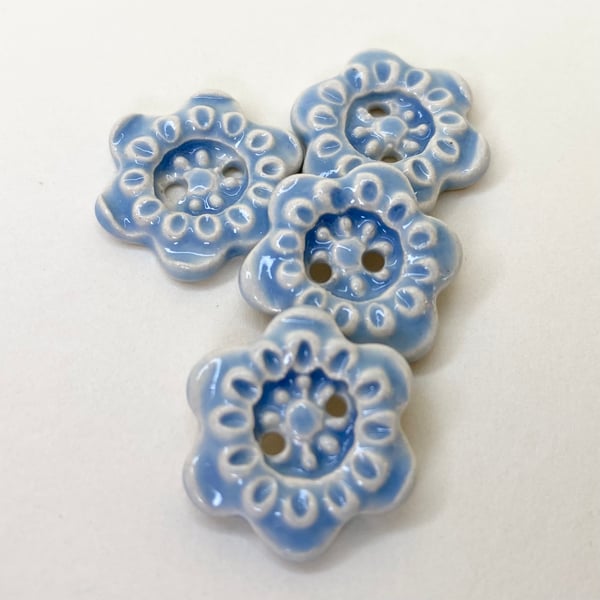 Set of four little handmade ceramic flower buttons blue