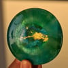 Handmade epoxy resin round coaster or paperweight. Green, blue, gold