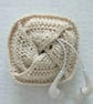 Small crocheted pouch for earbuds or sanitary items