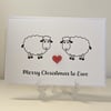 Merry Christmas to Ewe card with a red heart button between two sheep