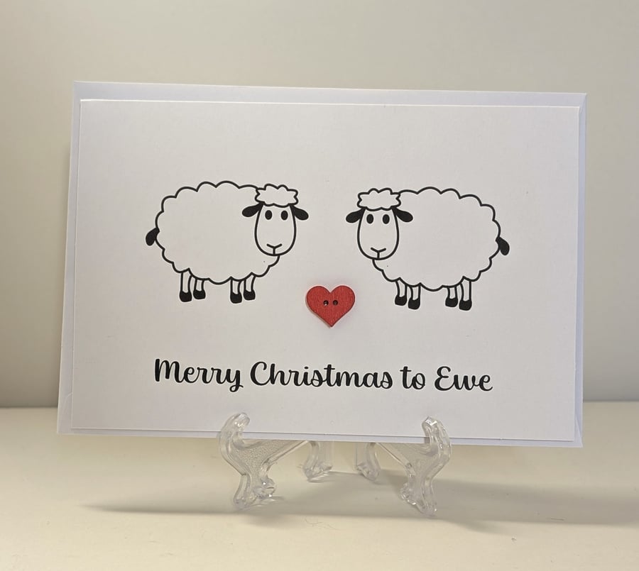 Merry Christmas to Ewe card with a red heart button between two sheep