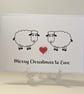 Merry Christmas to Ewe card with a red heart button between two sheep