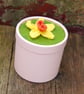 Pink cardboard cylindrical container topped with hand knitted daffodil - Image 2