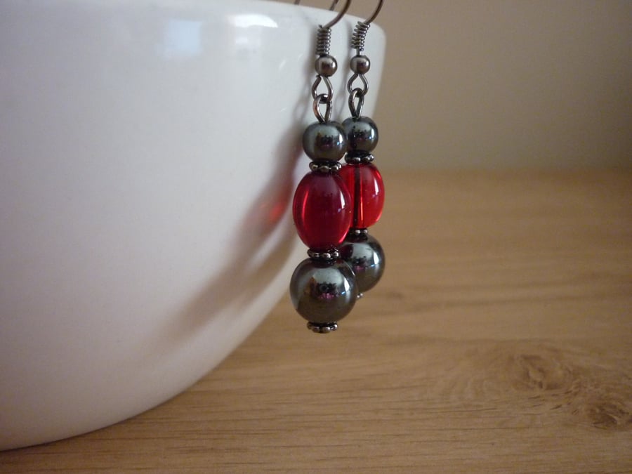 HEMATITE AND RED DANGLE EARRINGS.