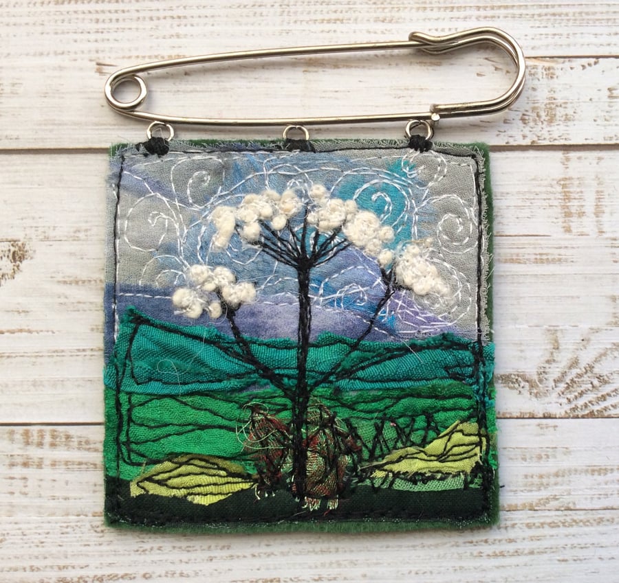 Embroidered wild flower kilt pin brooch.