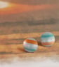 Circular stud earrings, sea and sand coloured stripes on anodised aluminium.