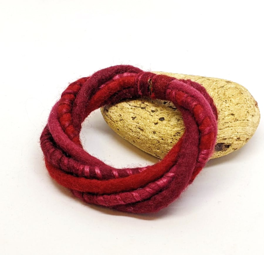 Felted merino cord bracelet in shades of red