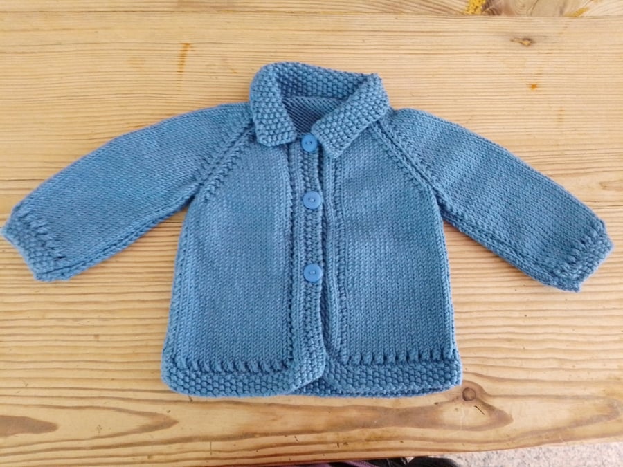 Baby cardigan handmade in denim blue merino wool to fit 3-6 months.