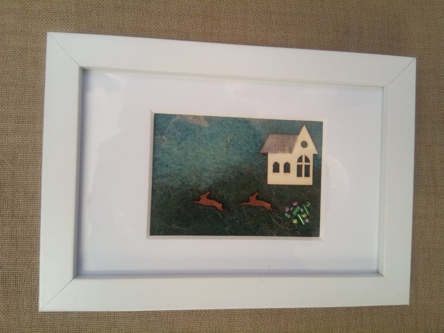 picture with felted background, wood and glass beads - hares