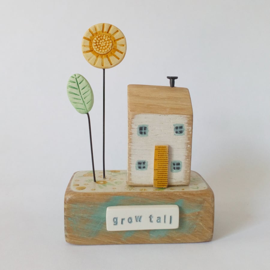 Wooden house with sunflower garden 'grow tall'