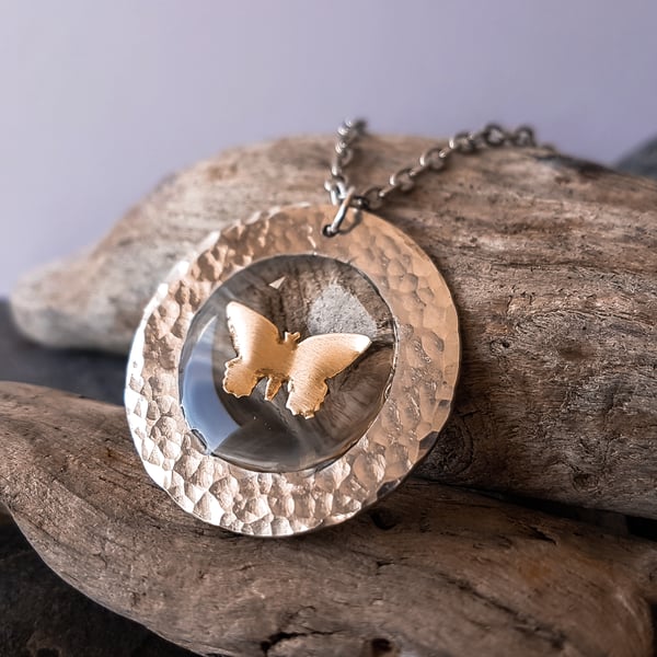Brass butterfly in resin and hammered silver tone metal circle pendant necklace