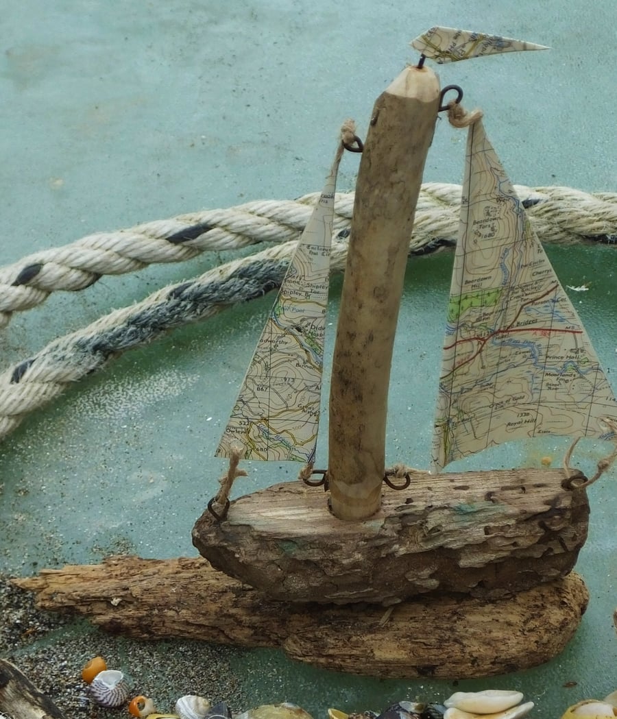 Little driftwood sailing ship yacht with ordnance survey map sails