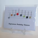 Dymunwyn Nadolig Llawen We wish you a Merry Christmas with music notes