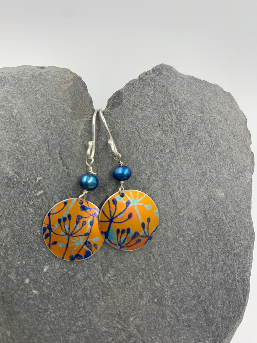 orange and blue aluminium cow parsley circle earrings with blue pearl 