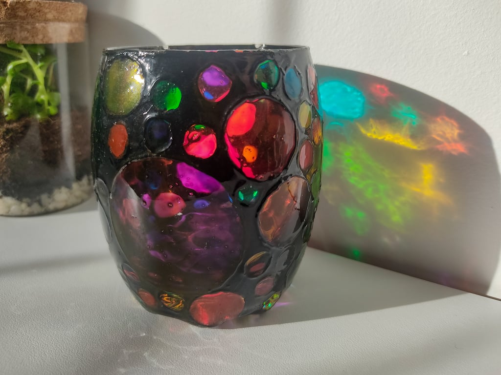 Stained glass effect painted tea light holder with multi-coloured circles 