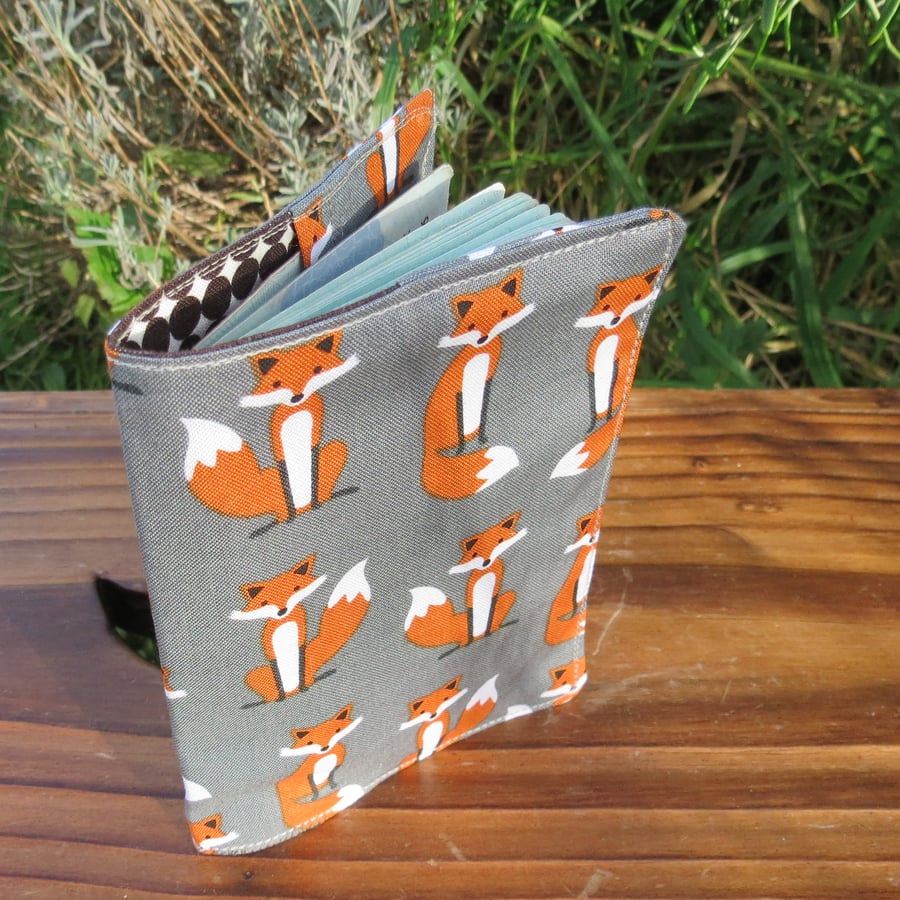 Foxes.  A fabric passport sleeve with a whimsical fox design.  