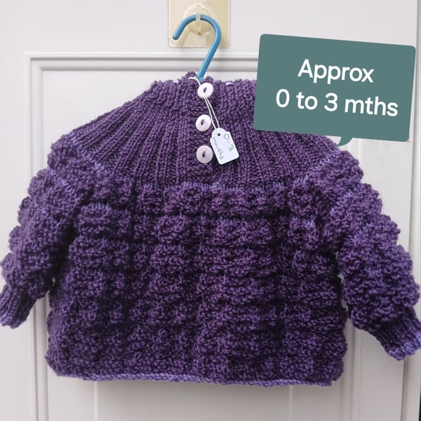 Hand knitted baby hooded jumper. Approx 0 to 3 mths. All proceeds to charity 