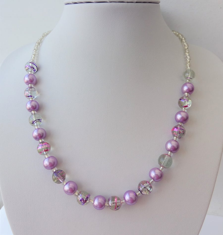 Purple pearl, purple and pink swirl and clear glass bead necklace.