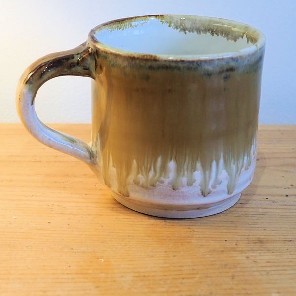 Stoneware pottery mug finished in a muli-colour amber,caramel cream glaze.