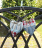 Pair hanging heart decorations on a seaside theme - Image 1