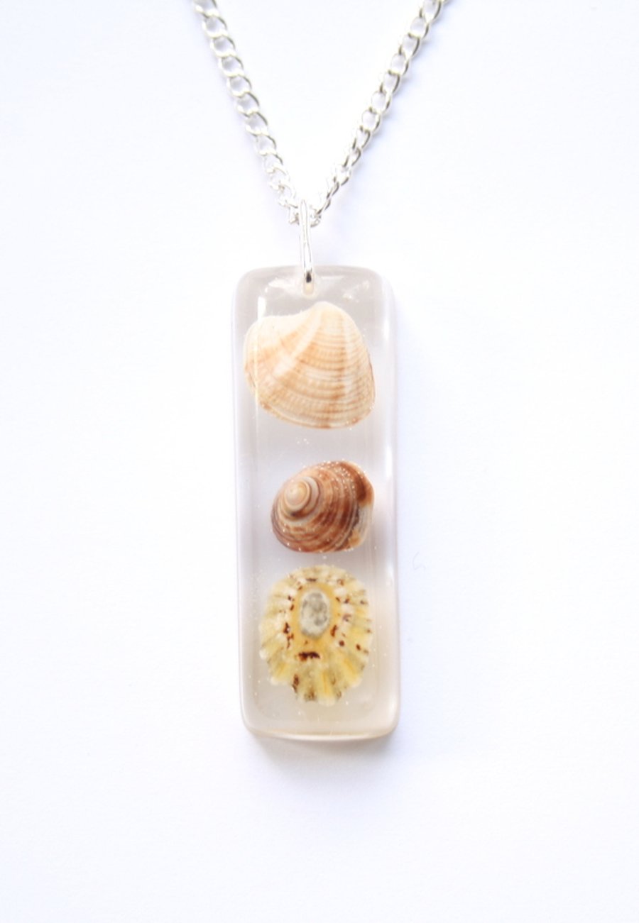 Shells in resin necklace.