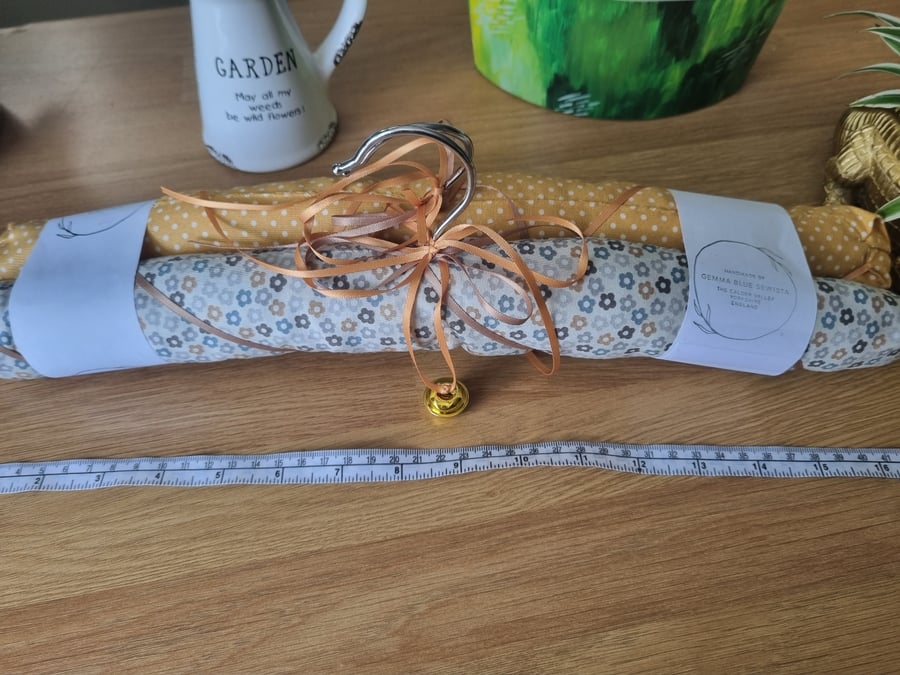 Pair of padded covered clothes hangers. Soft mustard & floral print.