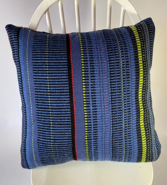 Hand woven 100% wool cushion in colbalt blues,lime green, cherry red stripes