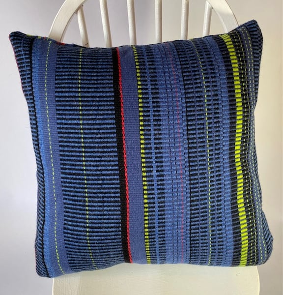 Hand woven 100% wool cushion in colbalt blues,lime green, cherry red stripes