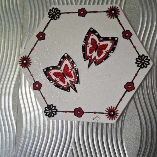 Red butterflies on canvas. 