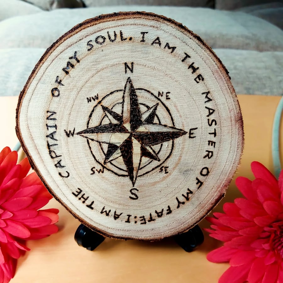 Invictus Poem surrounding an 8 sided compass, pyrography wood slice.