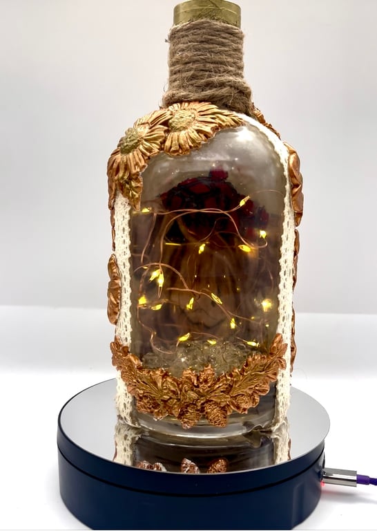 Light up cow bottle with clay flowers 