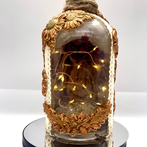 Light up cow bottle with clay flowers 