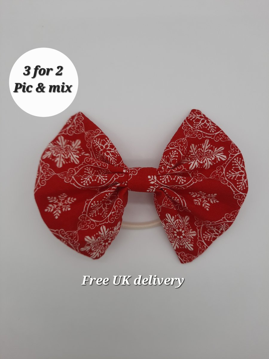 Hair bow bobble red with white snowflakes.