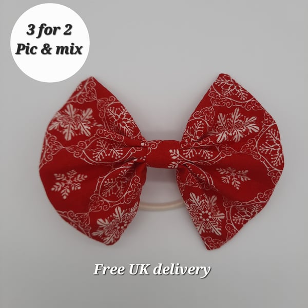 Hair bow bobble red with white snowflakes.