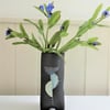 Stevie.  Unusual black ceramic 3-legged vase with abstract pastel motifs